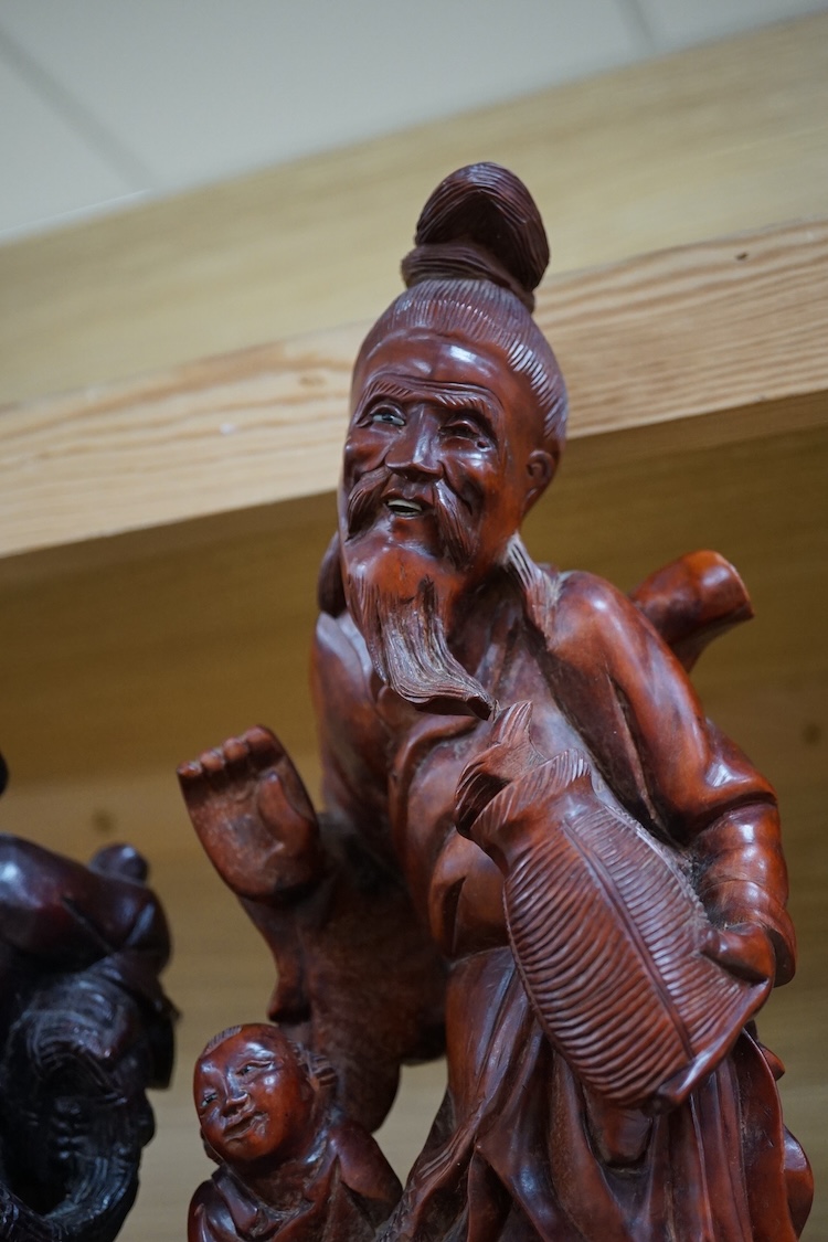 Three Chinese carved wood figures of elders, largest 37cm high